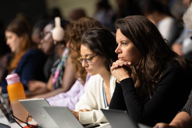 Delegates listen to the deliberations