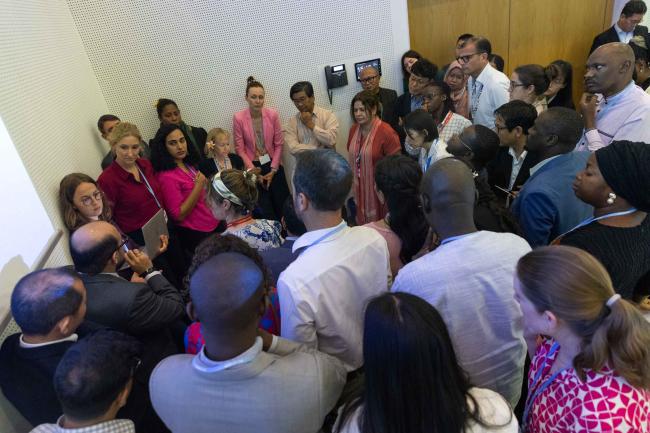 Delegates huddle during consultations on loss and damage
