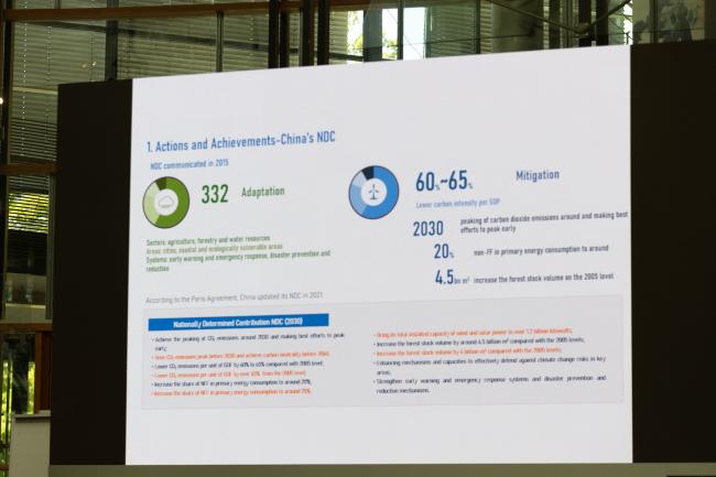 A slide highlights China's key achievements with their NDC