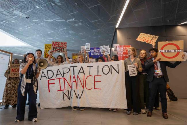 Members of civil society demonstrate in the corridors, calling for adaptation finance to be made available