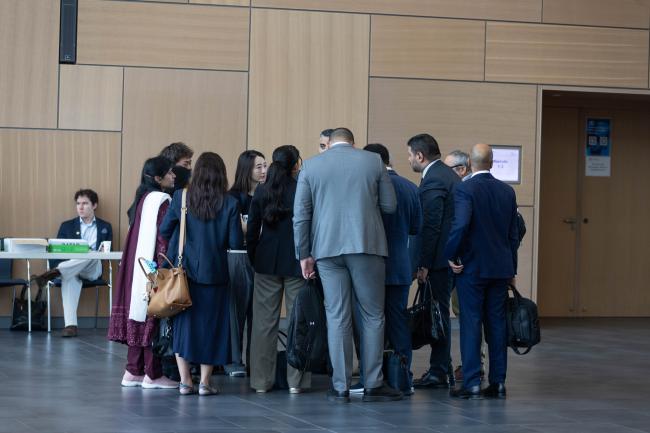 Delegates huddle informally in the corridors