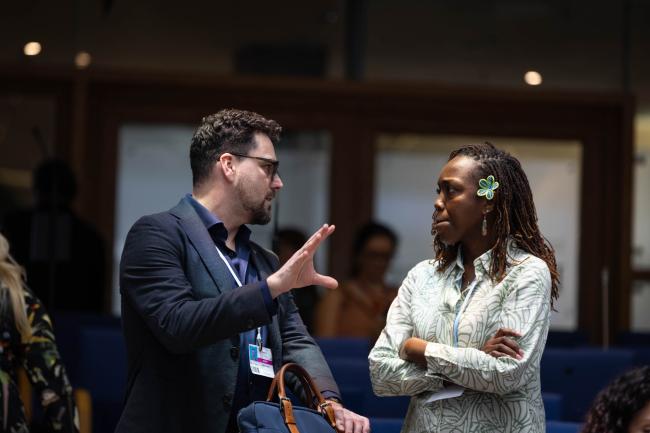 Peter Horne, Australia, speaks with Rueanna Haynes, Trinidad and Tobago