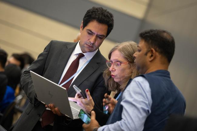 Delegates consult during discussions on the just transition work programme