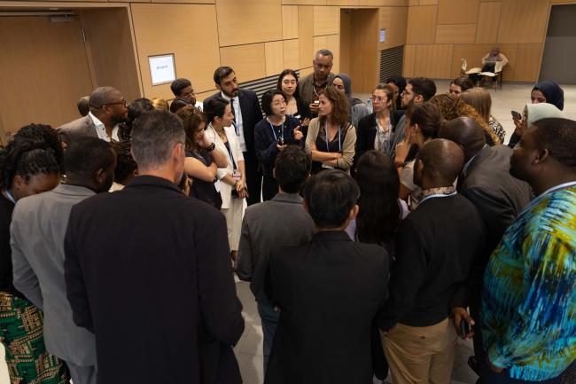 As negotiations enter their final stages, delegates huddle during informal consultations on adaptation communications
