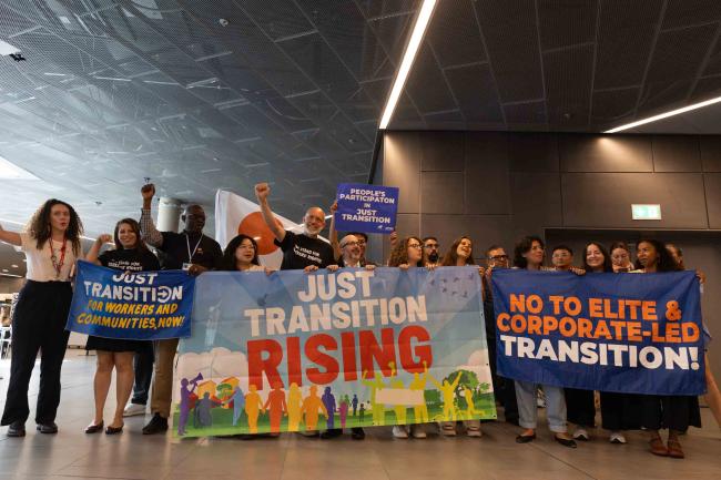 Members of different civil society constituencies demonstrate in the corridors, calling for greater action on the just transition, and for more concrete, equitable steps taken to protect workers
