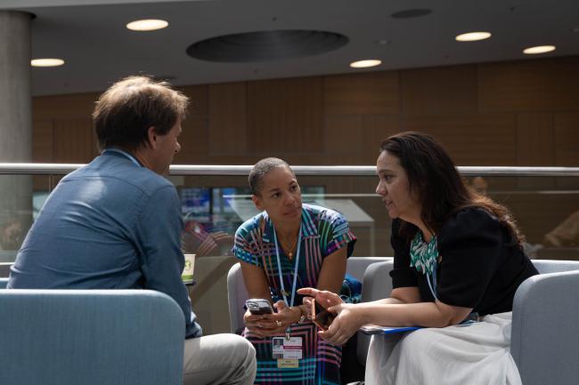 Ulrik Lenaerts, Belgium, Laurence Ahoussou, Canada, and Tina Stege, Marshall Islands, speak informally