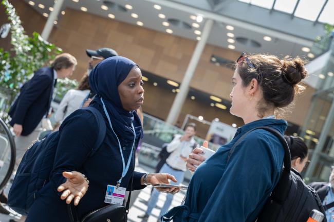 Isatou Camara, The Gambia, and Claire Holzer Fleming, UK, Co-Chairs for the informal consultations on the Adaptation Fund, speak between sessions