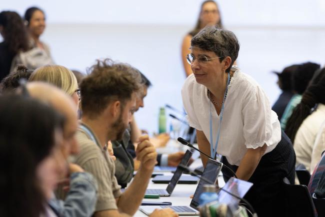 Delegates consult during informal discussions on the GGA