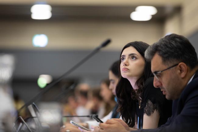 Delegates follow the text on screen as negotiations go into their final stages