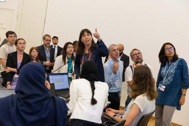 Delegates read the text projected on screen during informal discussions on research and observation systems