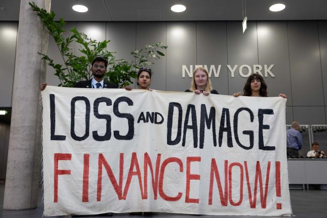 As negotiations continue behind closed doors, members of civil society silently demonstrate outside plenary
