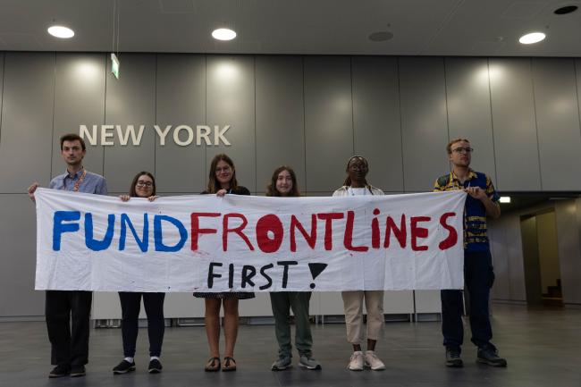As negotiations continue behind closed doors, members of civil society silently demonstrate outside plenary