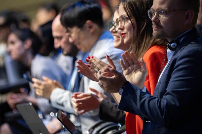 After two full days of intense negotiations, delegates applaud the adoption of the agenda