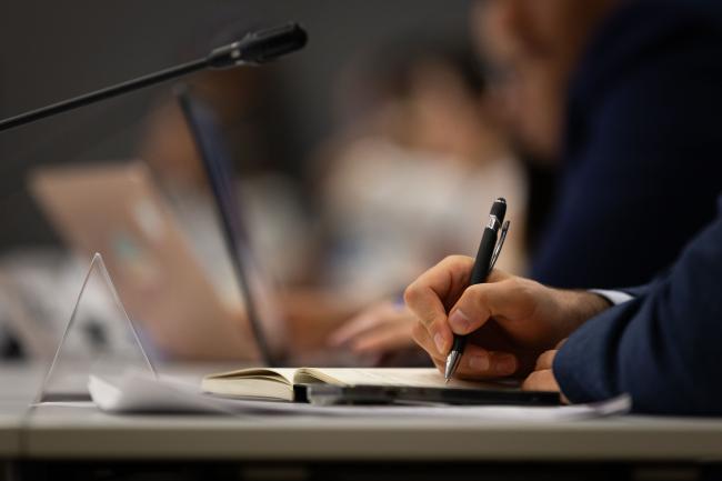 Delegates take notes