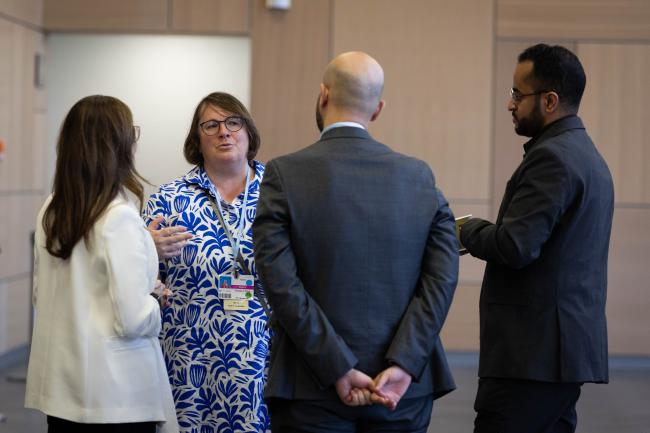 Elfriede More, Austria, speaks with delegates from Saudi Arabia