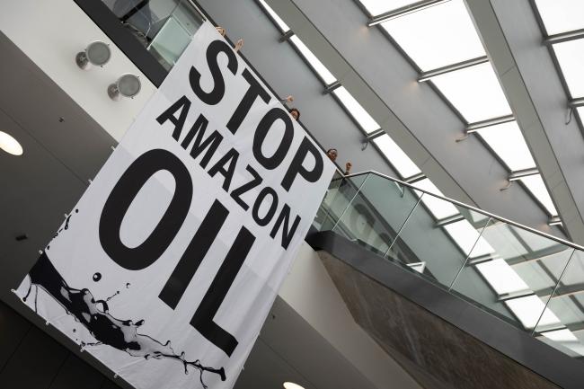 As informal consultations continue throughout the day, members of civil society demonstrate in the corridors, denouncing the launch of new fossil fuel projects in the Amazon