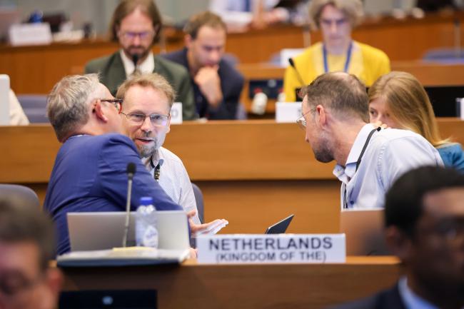 Delegates from EU consult during the session. 