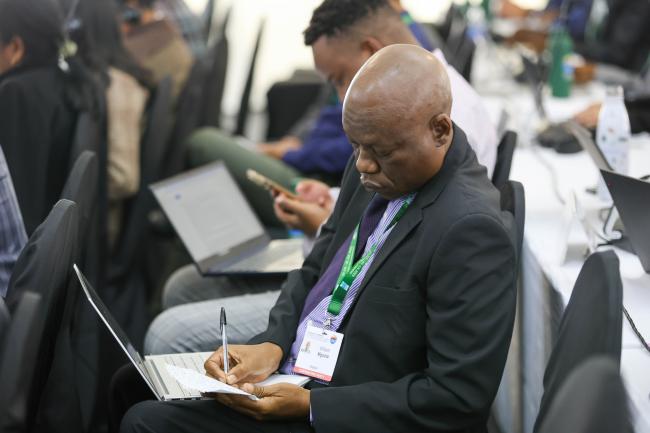 A delegate takes notes 