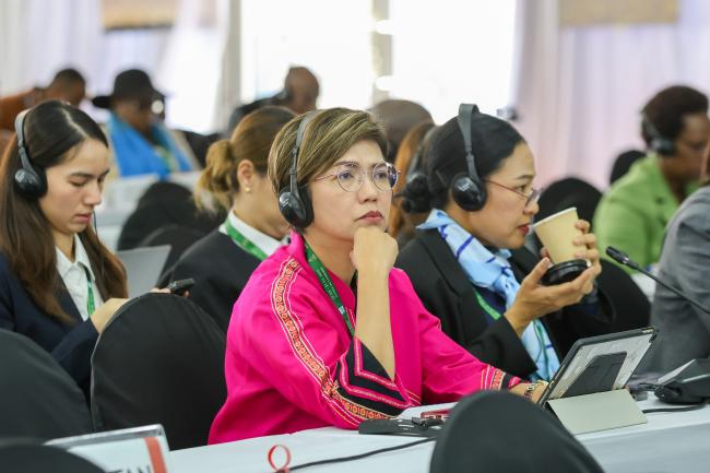 Delegates follow the proceedings 