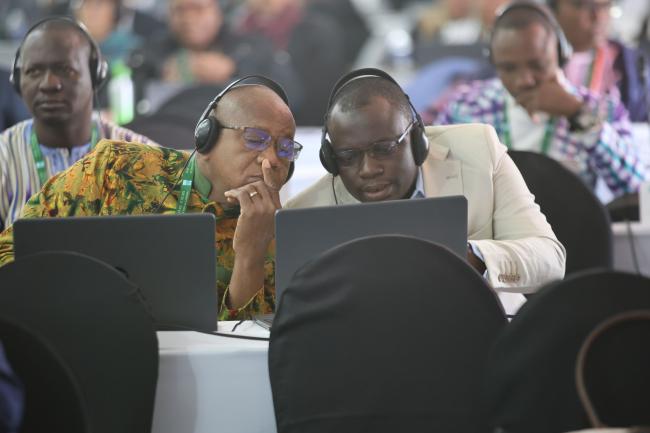 Delegates consult.