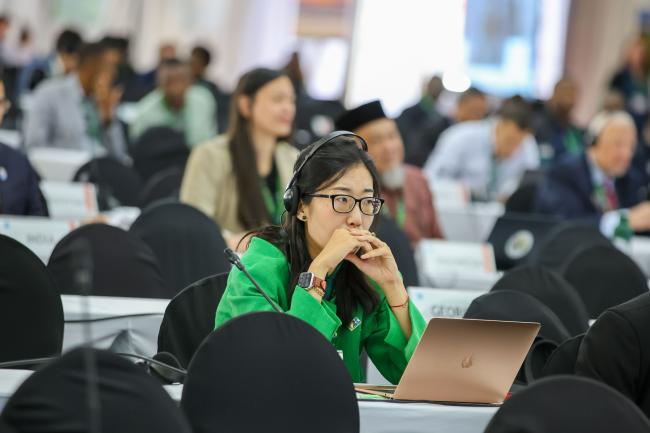 Delegates follow the proceedings. 