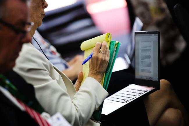 A delegate takes notes.