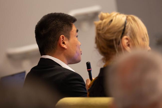 Journalists ask questions from the floor
