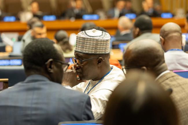 Delegates consult between sessions