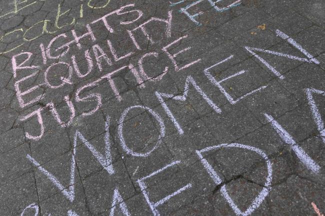 Activists write messages of solidarity across the streets