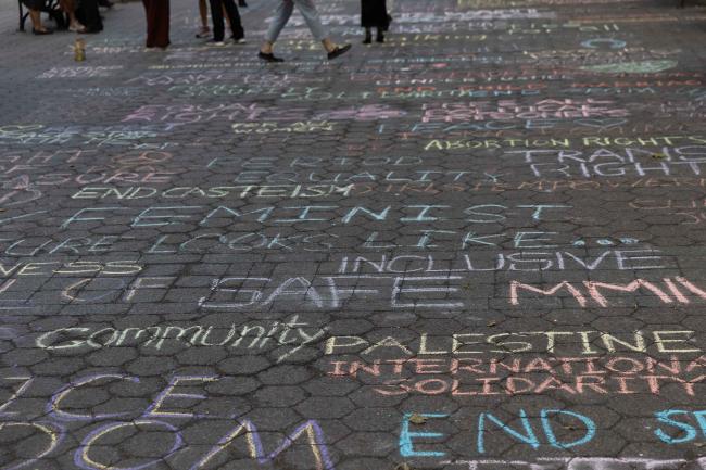Activists write messages of solidarity across the streets