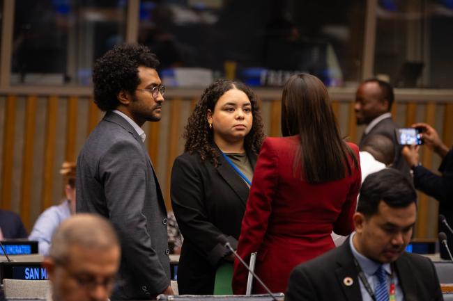 Delegates speak informally at the start of the day