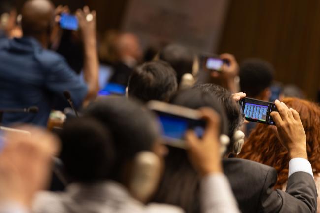 Delegates take photos of the voting results