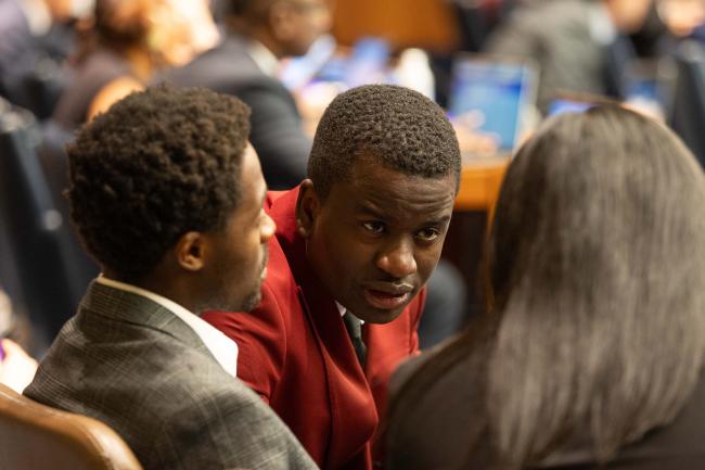 Delegates consult between sessions