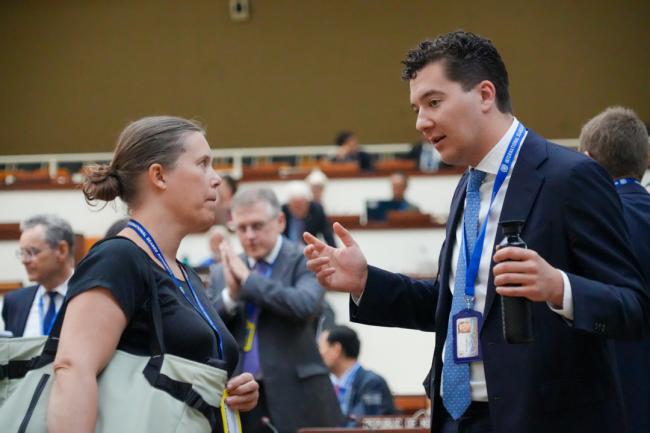Delegates talking before the session