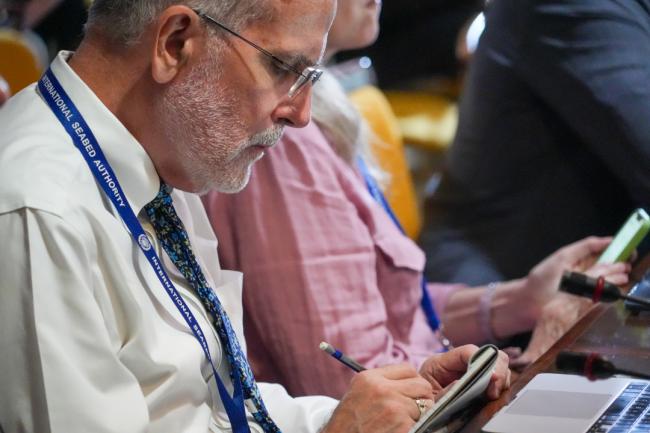 Delegate taking notes during the session