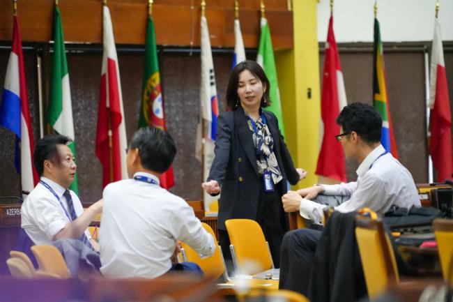 Delegates talking before the session
