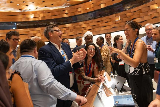 Delegates enjoy a moment together after the huddle