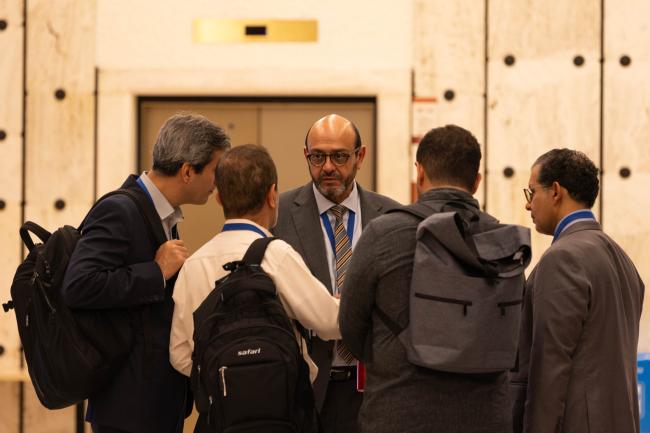 INC Chair Luis Vayas, Ecuador, speaks informally with delegates from Iran and Kuwait