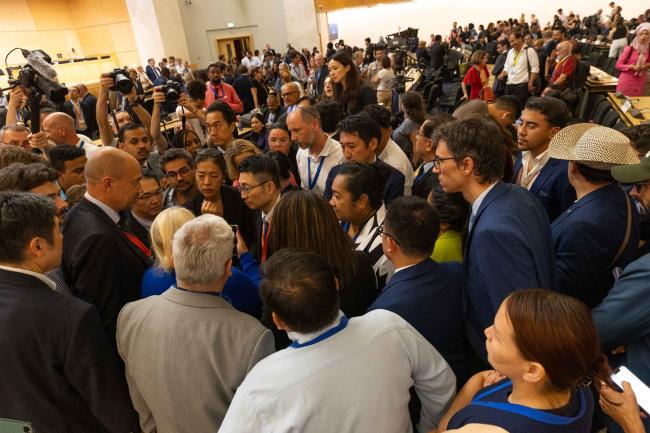 Delegates huddle to try find a way forward