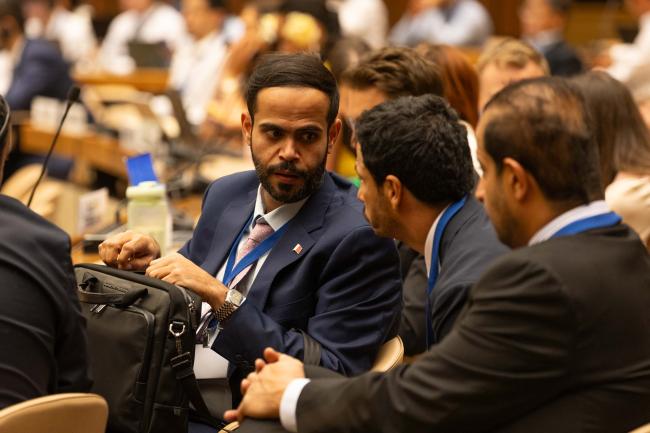 Delegates consult during the session