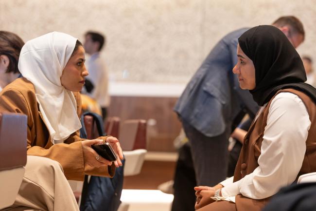 Delegates consult during the session