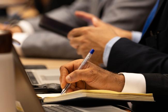 Delegates take notes