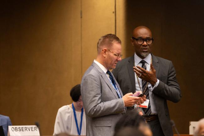 Richard Bryce Rudyk, Palau, speaks with Contact Group 4 Co-Chair Linroy Christian, Antigua and Barbuda