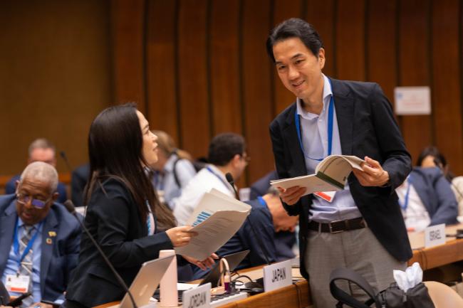 Delegates speak informally between sessions