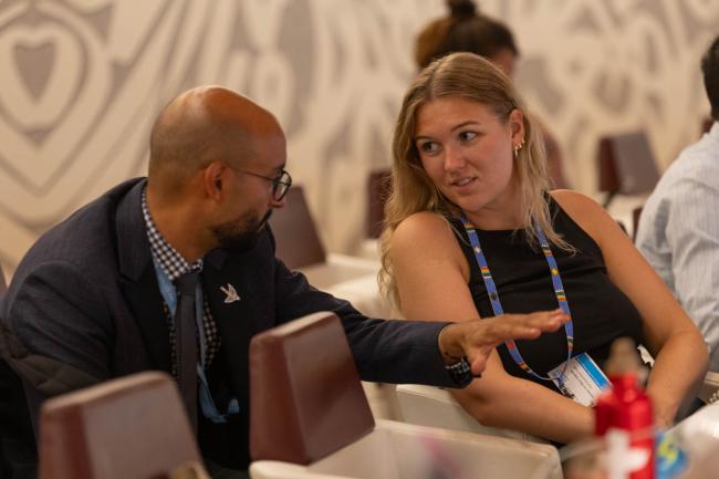 Delegates consult during the session