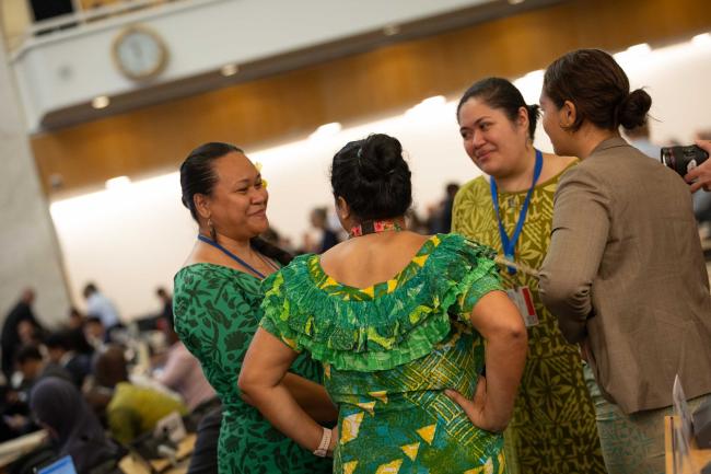 Delegates from the Pacific islands wear green to show their unity and solidarity within the region