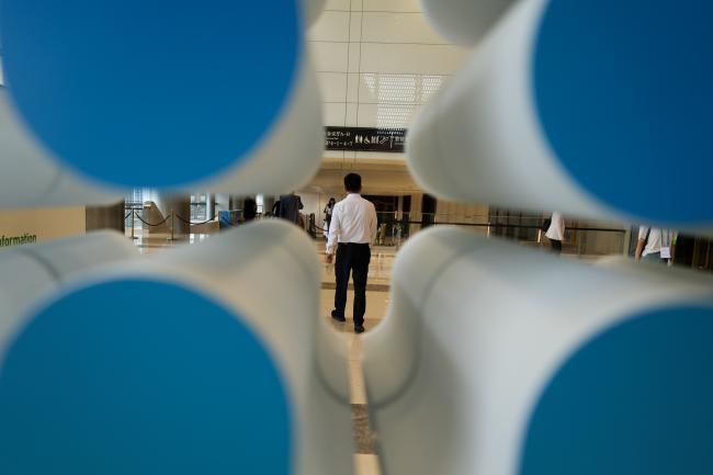 A man passing in front of a welcome sign at the conference