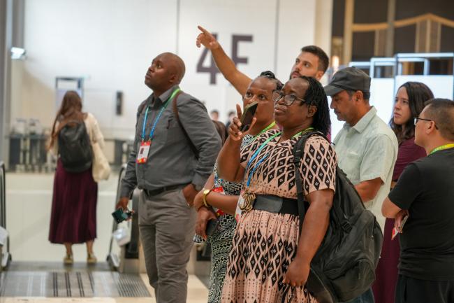 Participants looking at the conference schedule