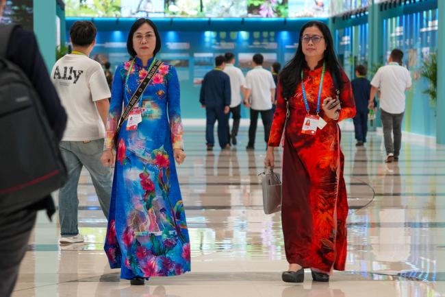 Two women walking to the conference room