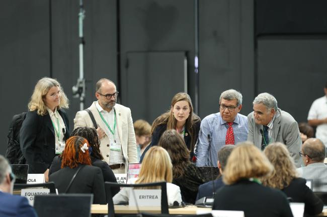 Participants forming a huddle during the afternoon plenary